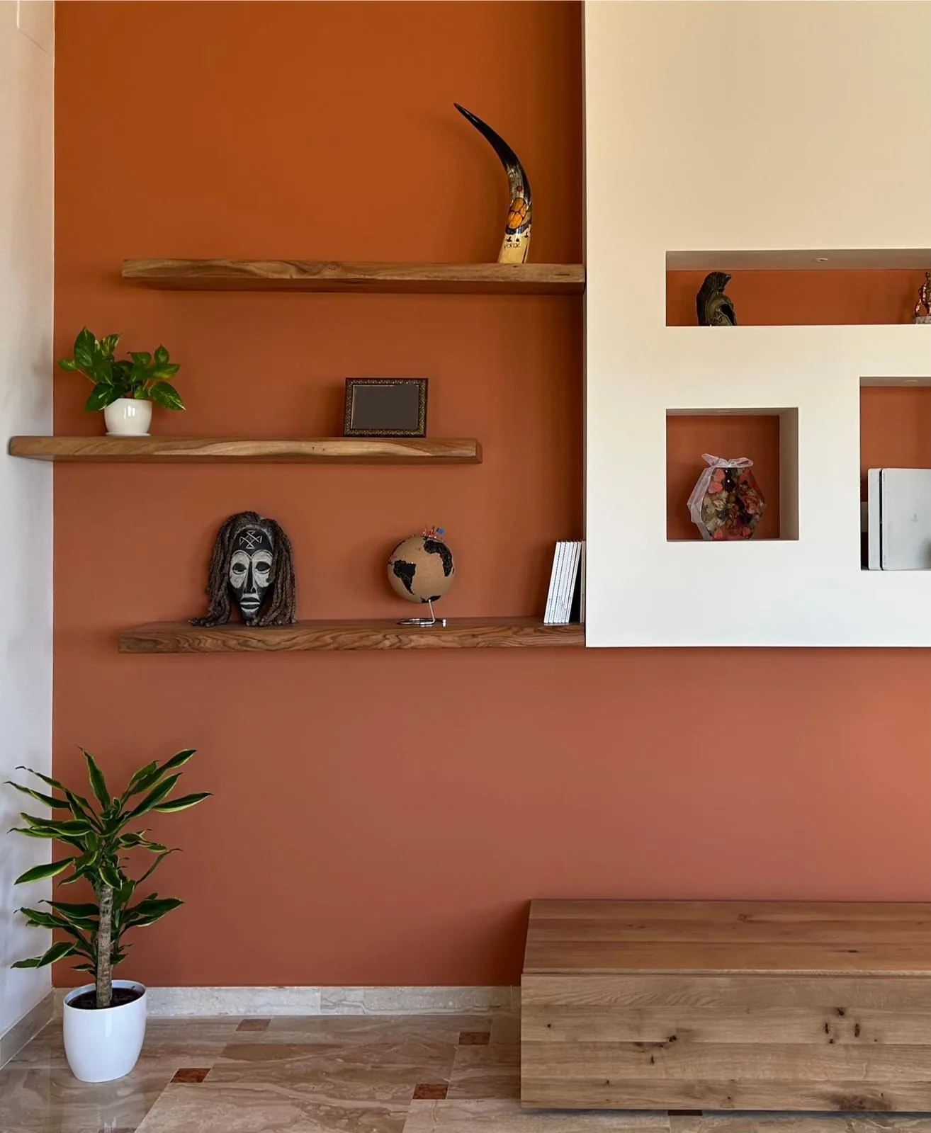 The equipped wall created, with wooden shelves and niches for objects
