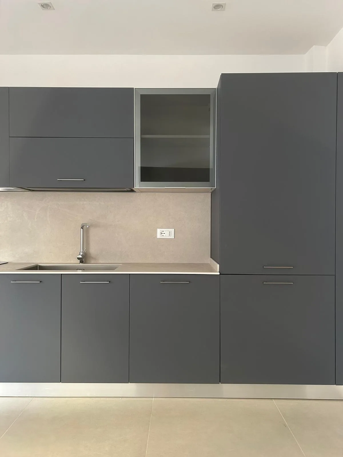 The kitchen created, with dark green doors and light worktop