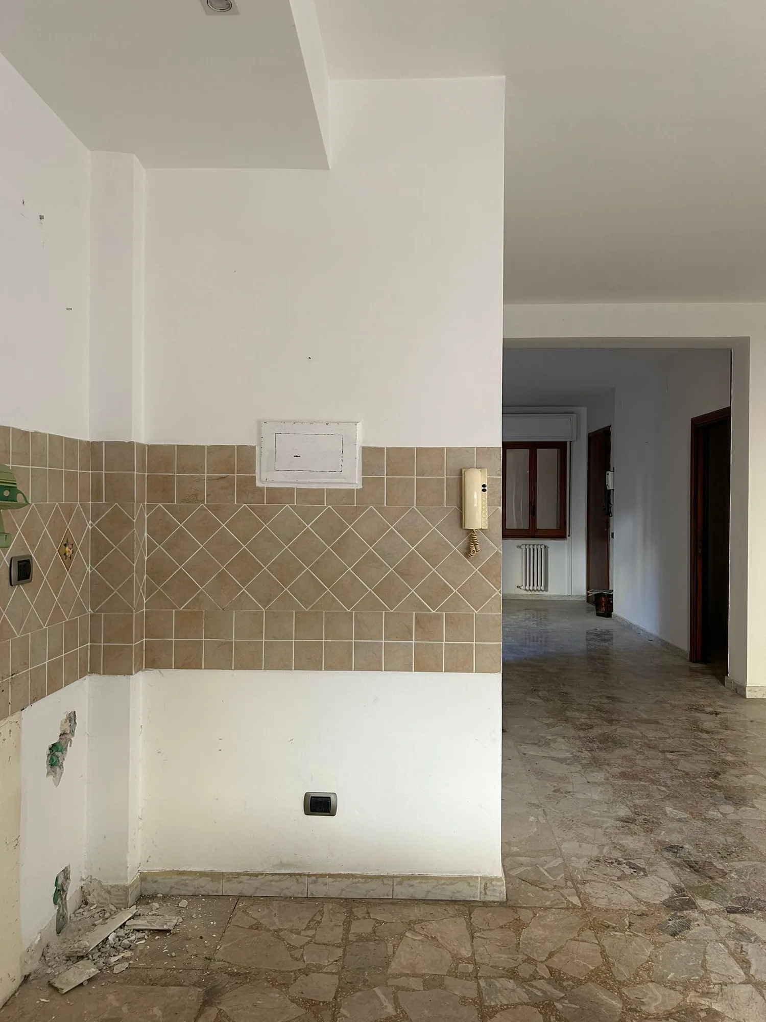 Room before the works, with tiled base and original floor