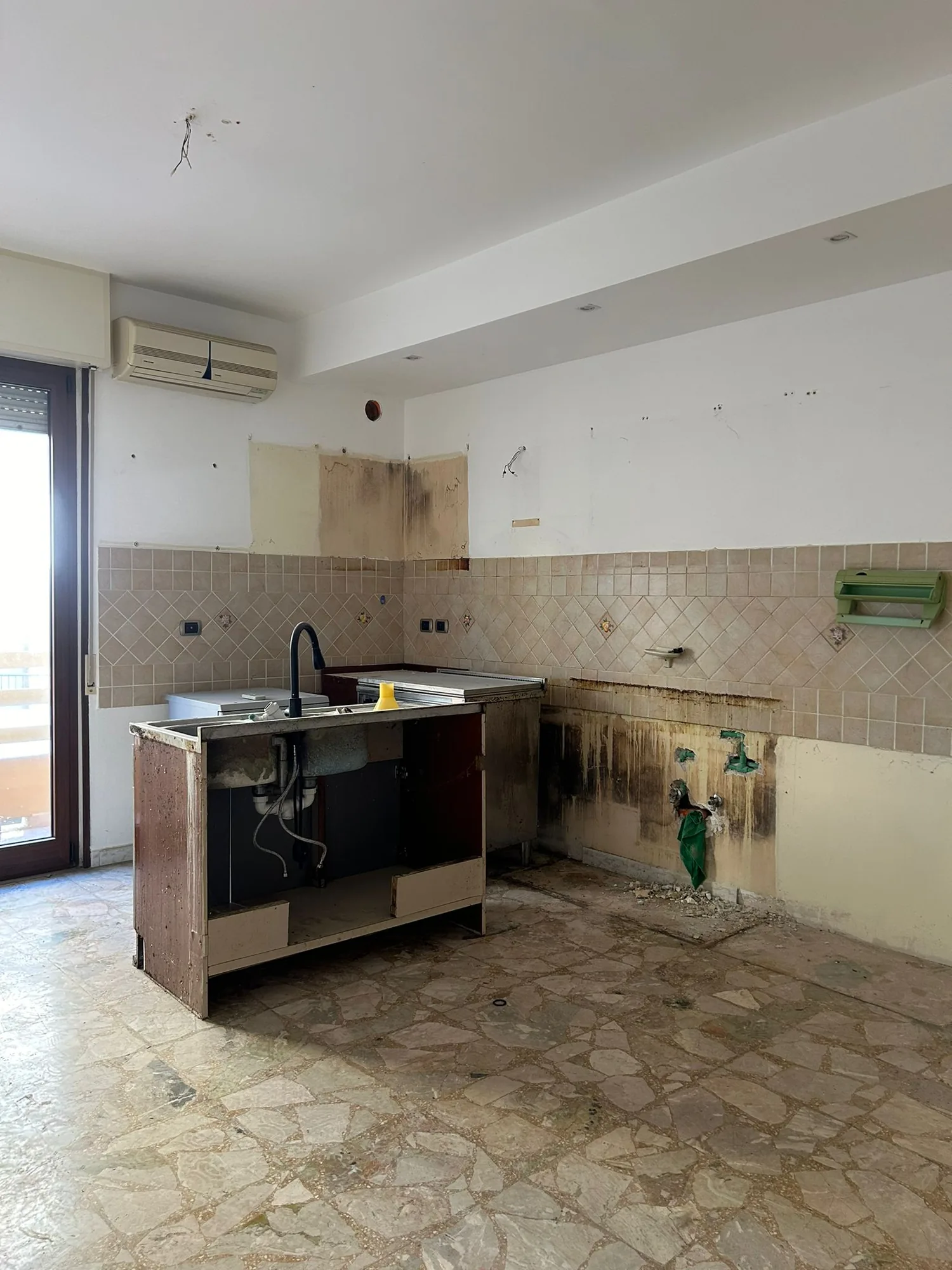The old kitchen before demolition, with tiled covering