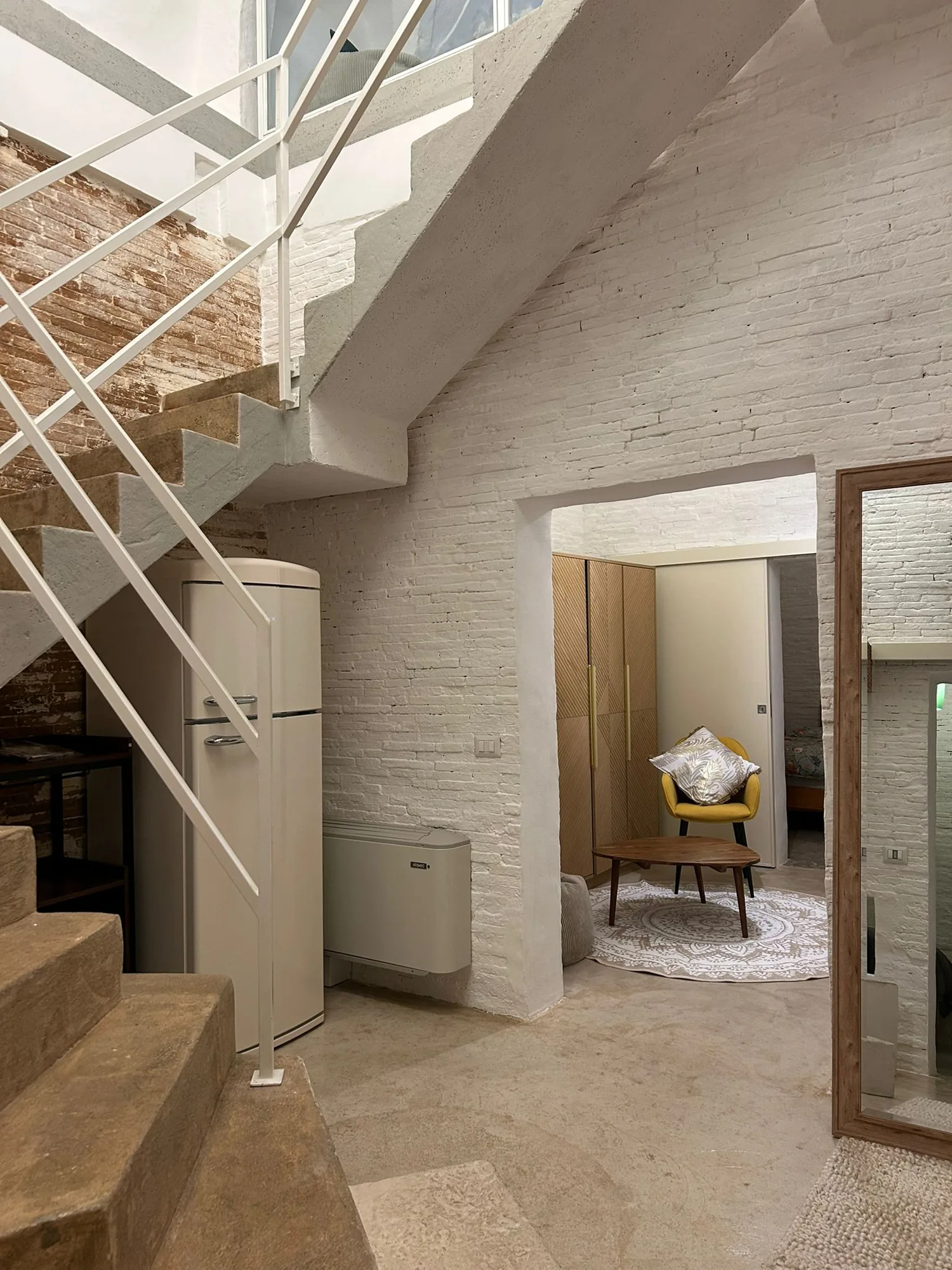 The staircase to the upper floor, with the recovered rooms at the bottom