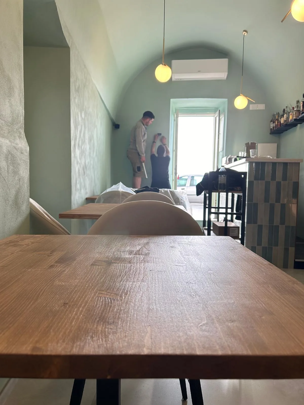 Installation of the furnishings with the walls already painted in sage green