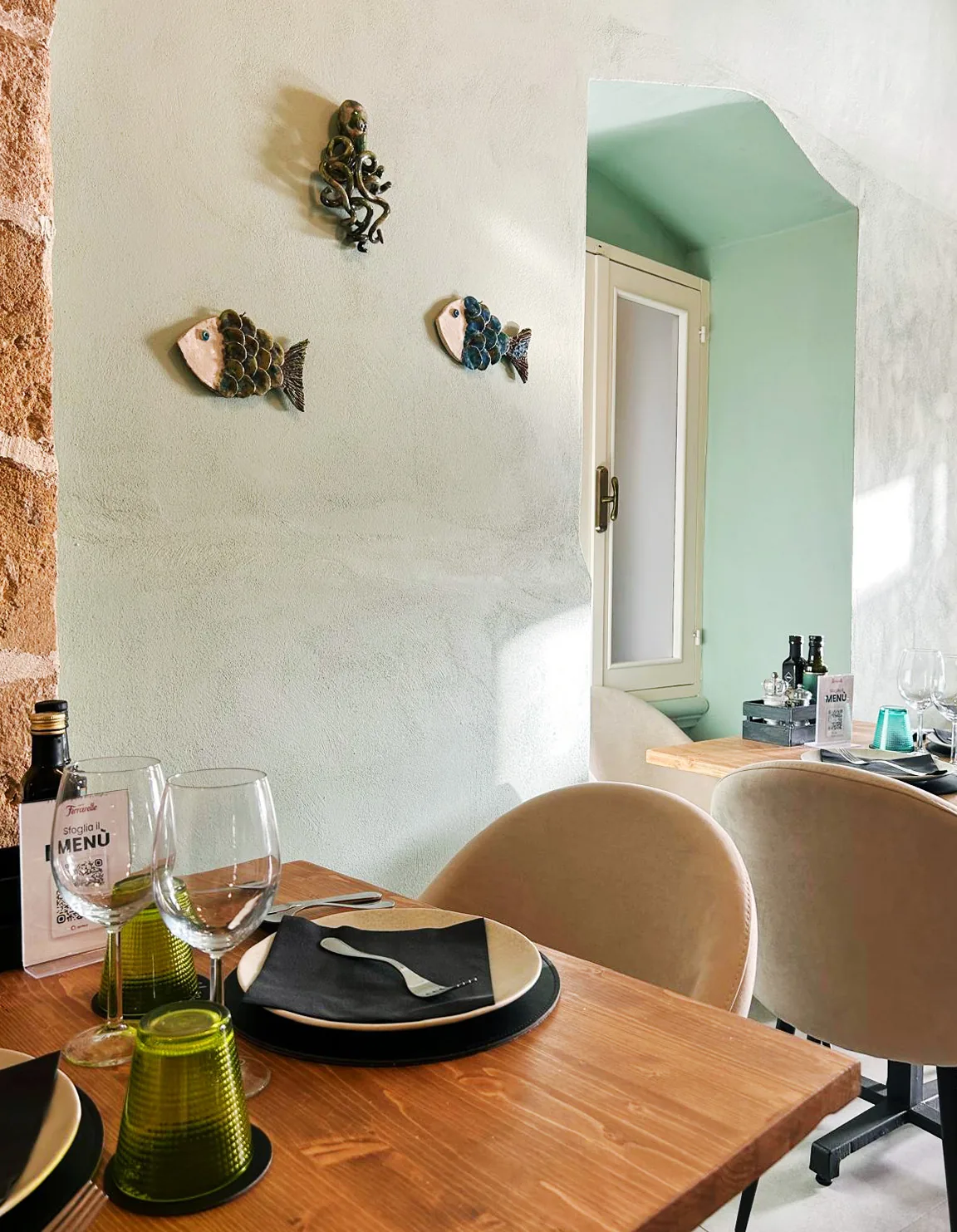 Table set with fish decorations on the green wall