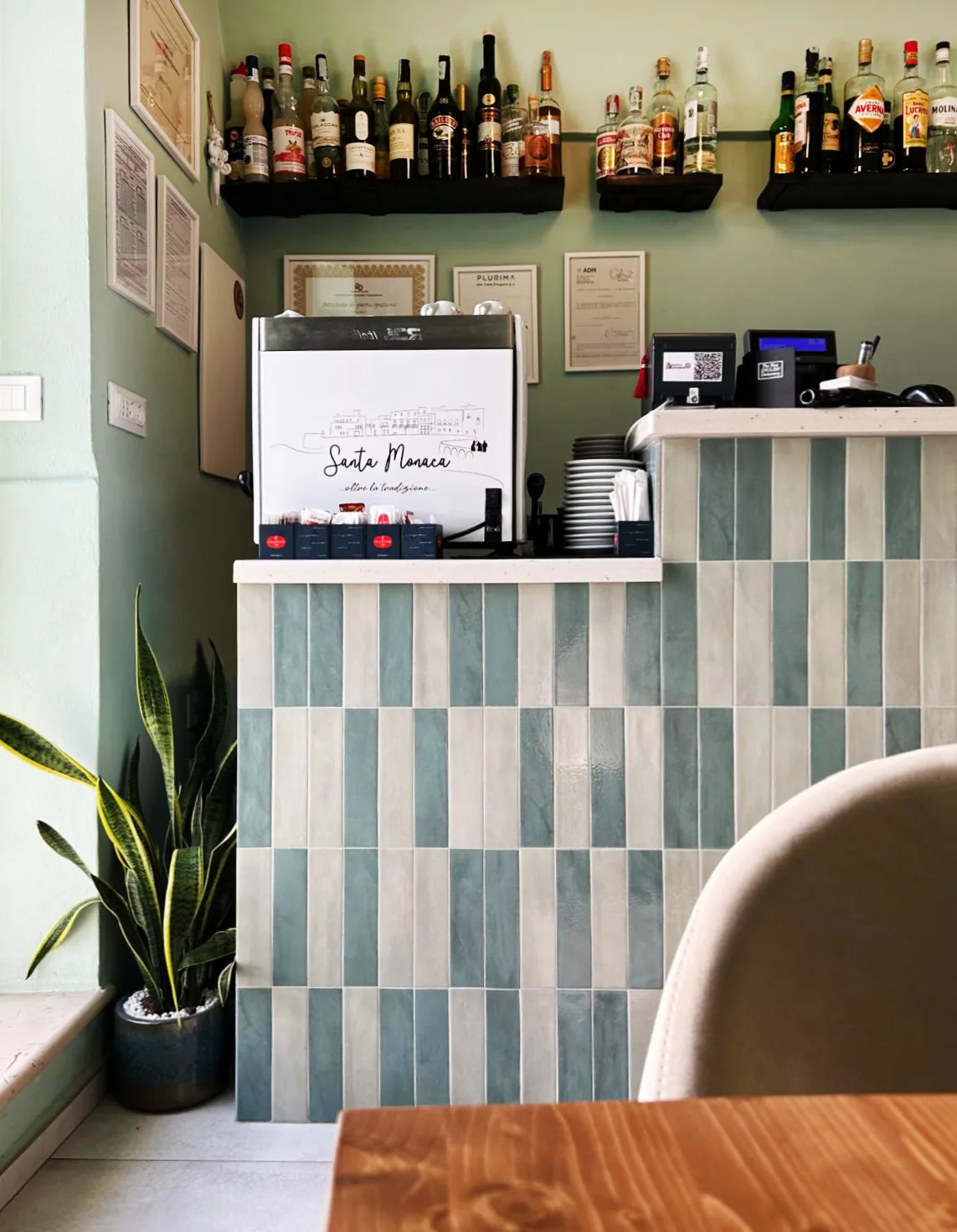 The counter covered in striped tiles, with the bottle shop behind it